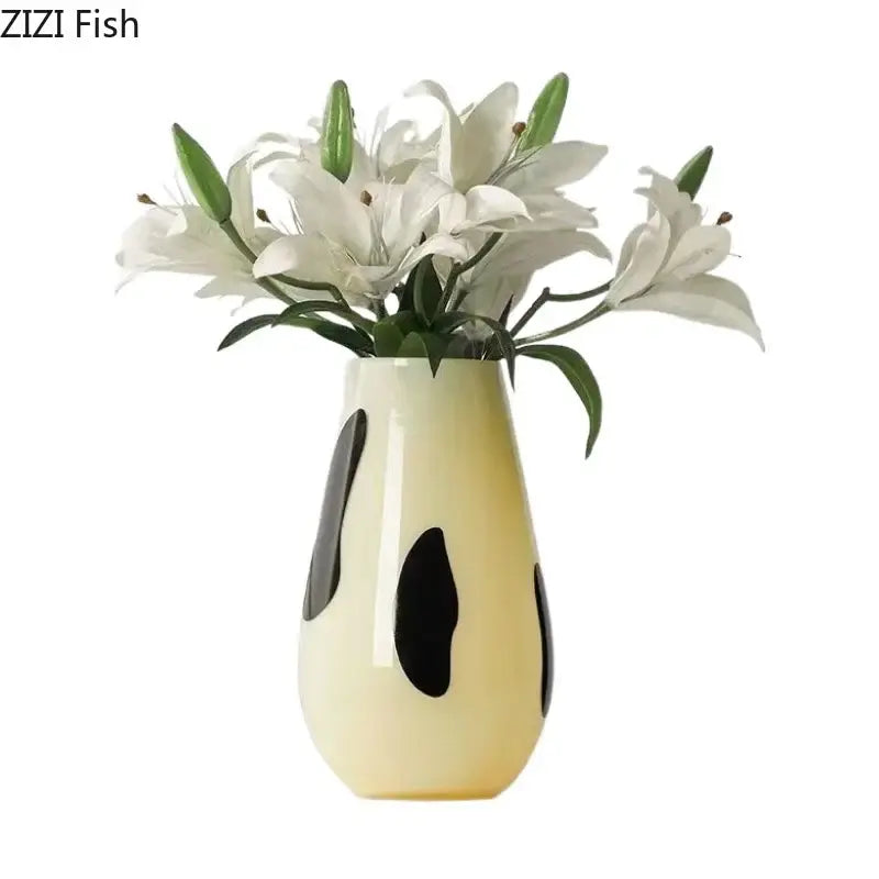 Cream-colored ceramic vase with black stripes holding white lilies ideal for decorbites black stripes living room decor