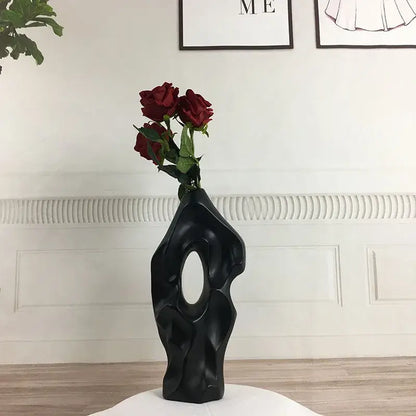 Black abstract ceramic vase with central oval opening and deep red roses for living room decor by decorbites black white abstract ceramic