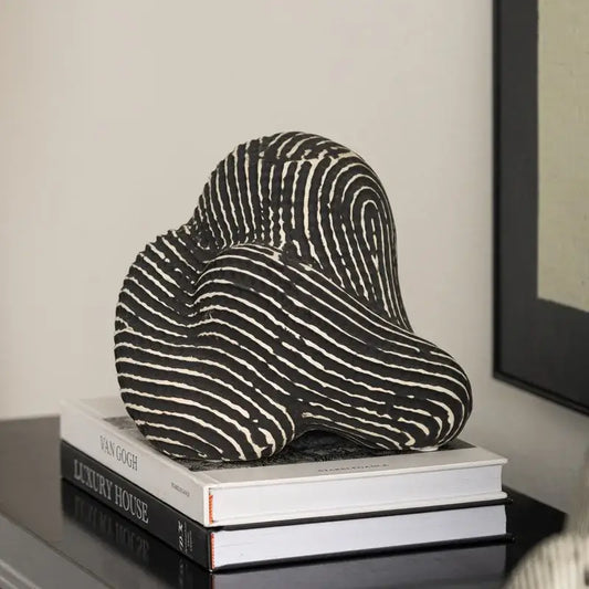 Abstract black and white striped ceramic geometric stone rockery sculpture with flowing design for living room display