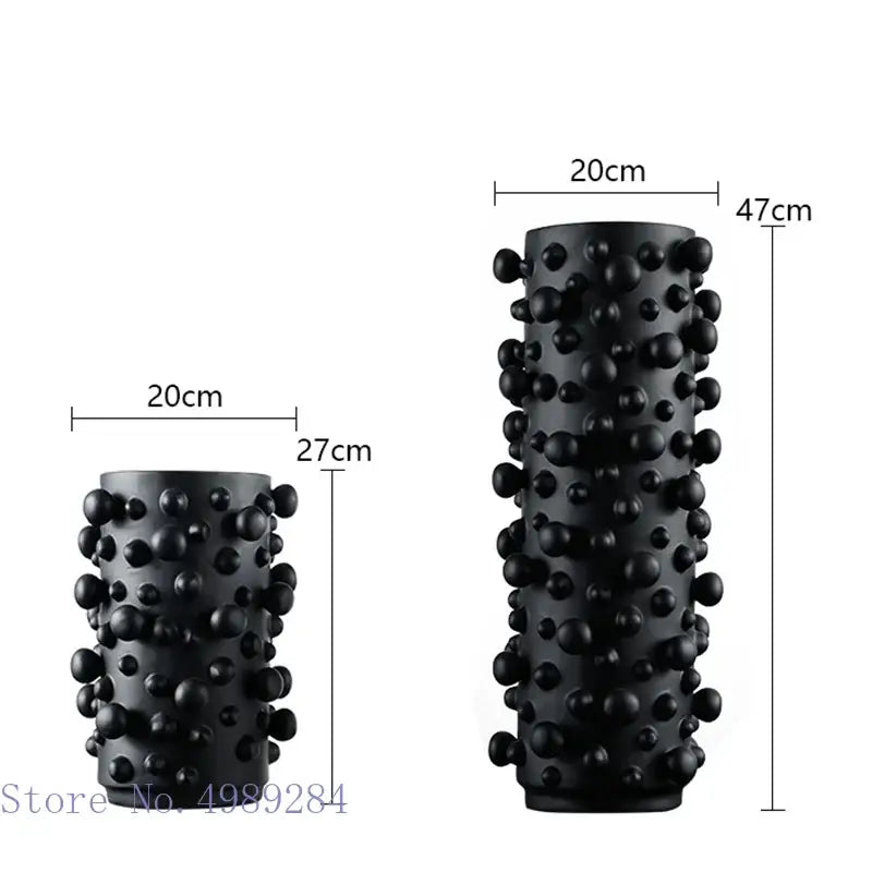 Black cylindrical foam roller with irregular bumps textured surface used for decorbites black white living room decor