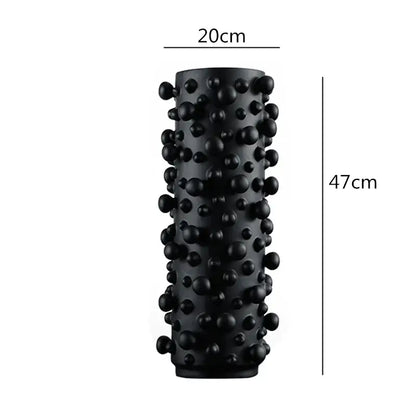 Black cylindrical foam roller with irregular bumps and rounded protrusions for decorbites black white living room decor