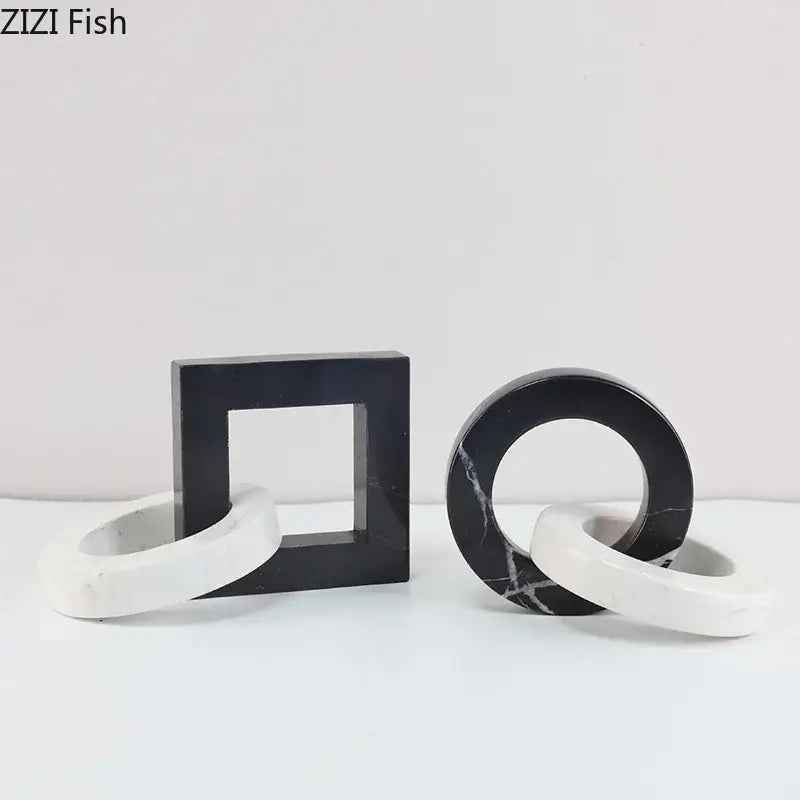 Black and white marble geometric knot bookends with abstract square ring design as a modern living room statue
