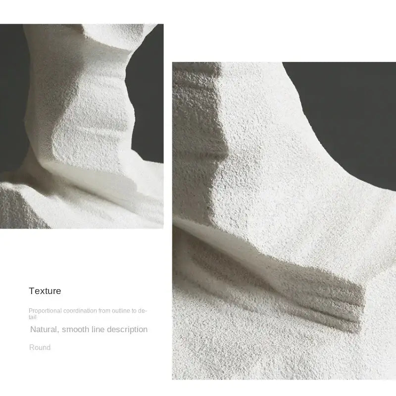 White plush terry cloth bath towel with soft textured surface and rounded edges beside abstract resin decoration sculpture