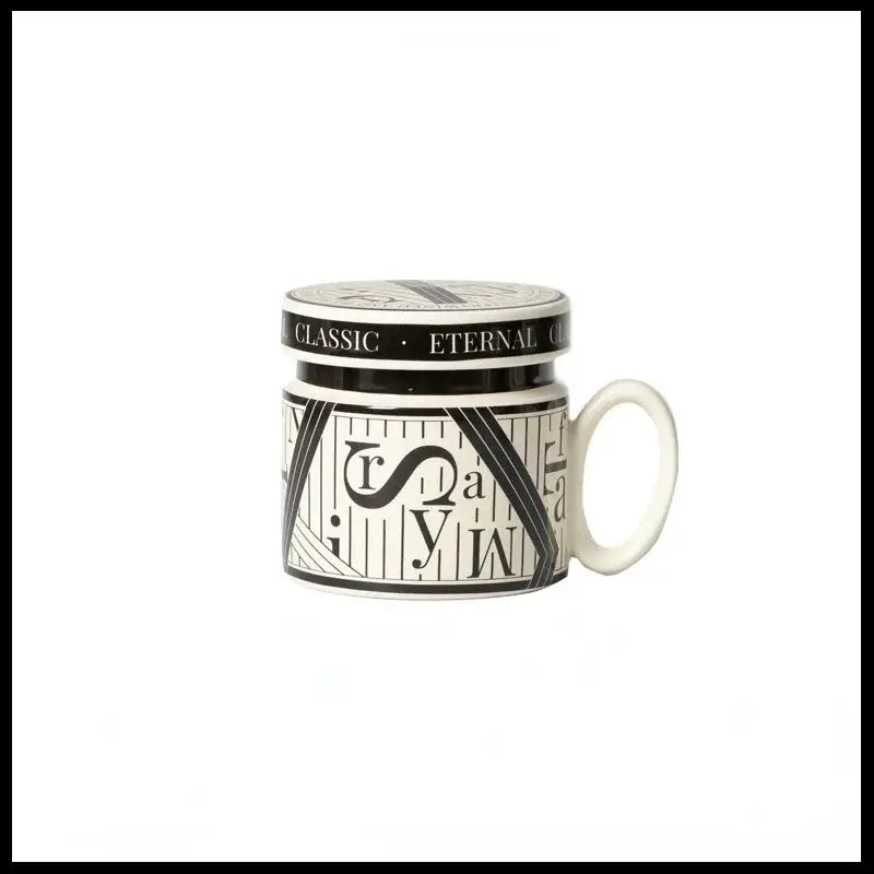 A white ceramic espresso cup with black and white geometric design and classic eternal lid for personalized french coffee