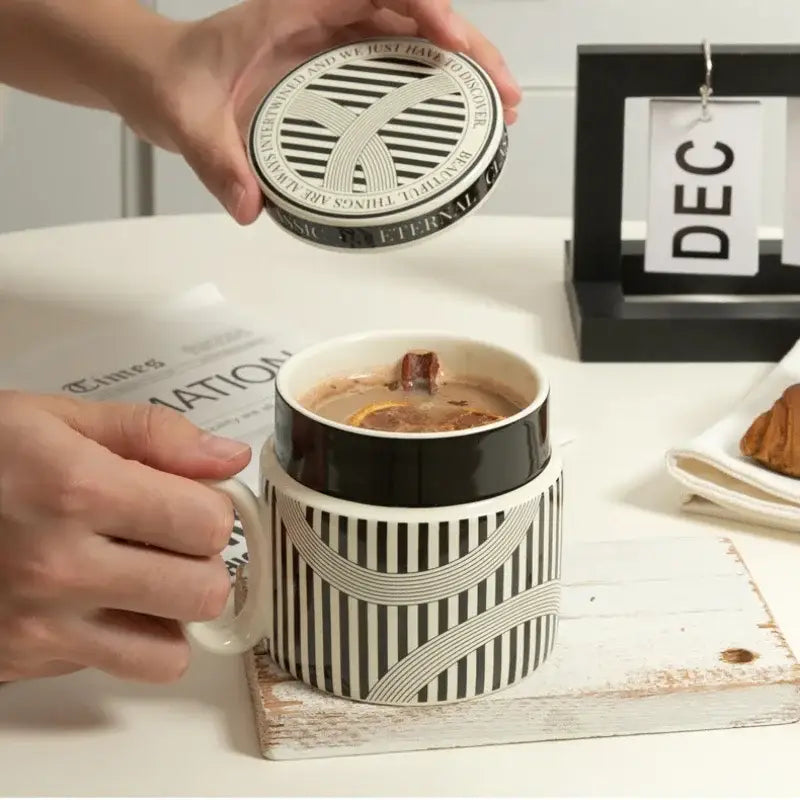 Black and white striped ceramic espresso cup with matching lid featuring abstract geometric pattern for personalized french coffee gift