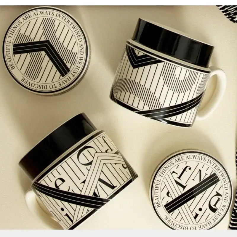 Black and white ceramic espresso cups with geometric line patterns and bold black rims perfect for personalized french coffee gifts