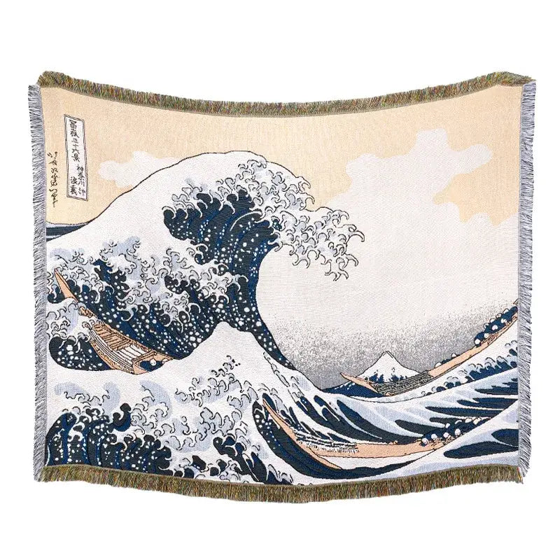 Beige throw blanket with woven great wave off kanagawa design and geometric knitted tassels for bedroom use