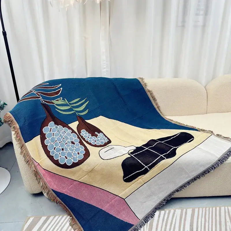 Cozy multicolored throw blanket with abstract fruit design and geometric knitted tassels in navy blue and beige
