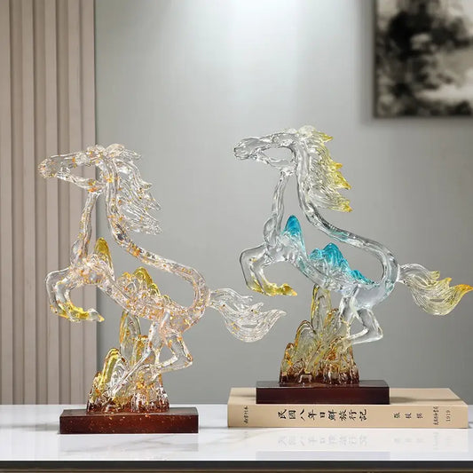 Two translucent crystal horse statues with blue and gold accents on dark wooden bases for living room decorbites decor