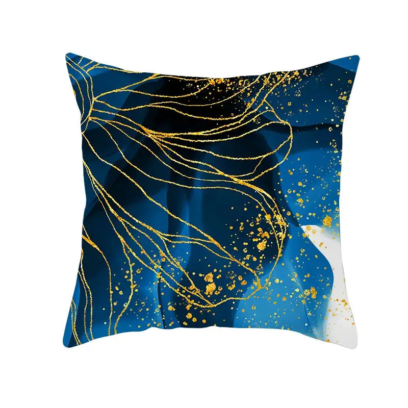 Square throw pillow with blue ink background featuring flowing gold edge lines and scattered golden speckles cushion cover