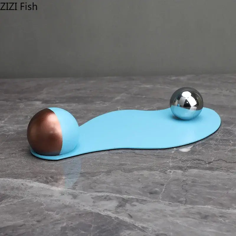 Abstract blue liquid ornaments desk sculpture with sleek curved plastic base and copper and silver metallic spheres