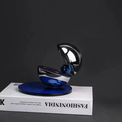 A sleek home decor sculpture featuring glossy black and blue decorbites crystal glass semi-circle ornaments on cobalt base
