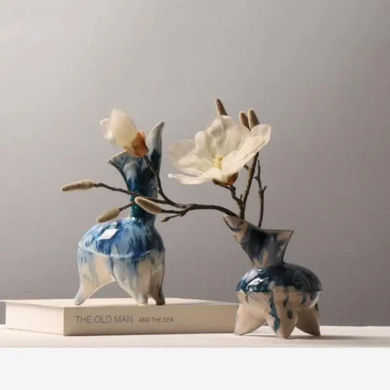 Two hand-painted ceramic vases with blue and white irregular ink pattern and three-legged base for living room decor