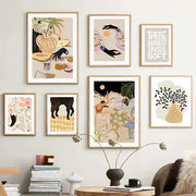 Set of six framed wall art prints featuring abstract girl hand and botanical designs in light wood frames for living room decor