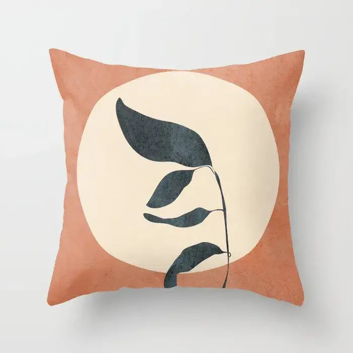 A terracotta square decorbites decorative pillowcase with abstract dark gray leaves on a cream circular background