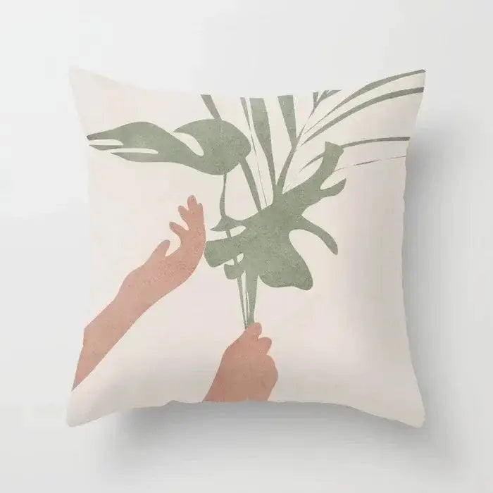 Cream-colored decorbites decorative pillowcase with minimalist hands holding muted green tropical leaves for living room decor