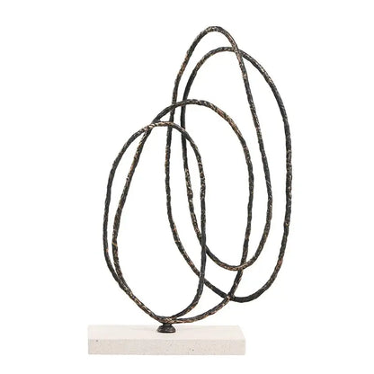 Abstract geometric face sculpture with intertwined black metal rings and rustic patina on white stone base for living room