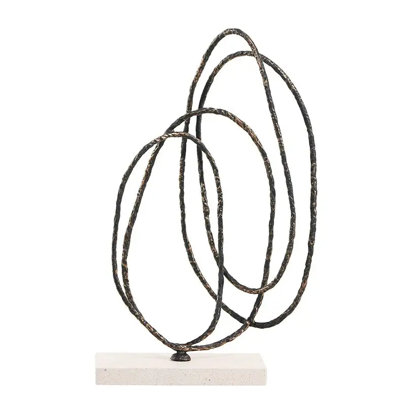 Abstract geometric face sculpture with intertwined black metal rings and rustic patina on white stone base for living room