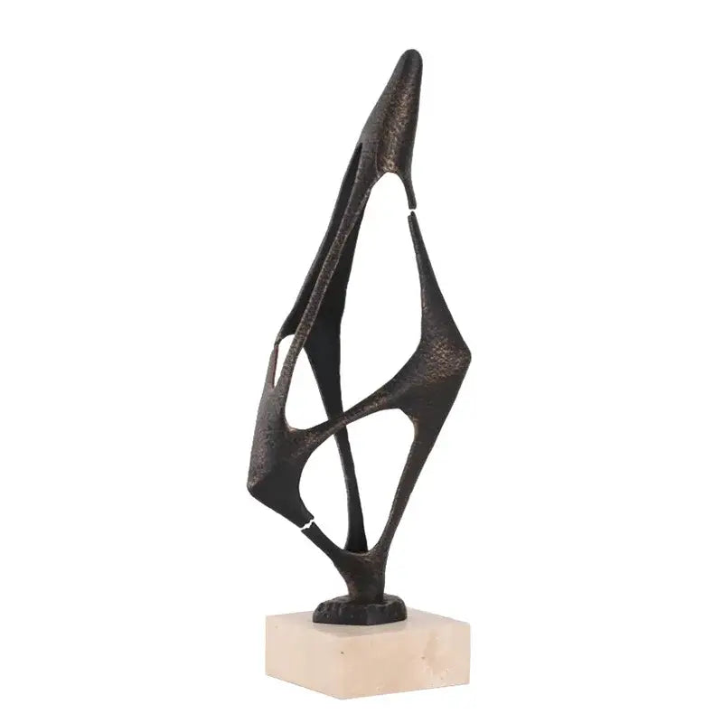Abstract black metal geometric abstract face sculpture with angular interlocking forms on beige marble base for living room