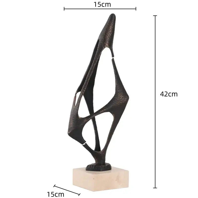 Abstract black metal geometric abstract face sculpture with textured oxidized finish on beige marble base for living room
