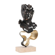 Abstract bronze and gold geometric abstract face sculpture with cut-out details on a stone base for living room display