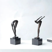Two abstract bronze diving sportsman metal sculptures on black marble bases for living room decor