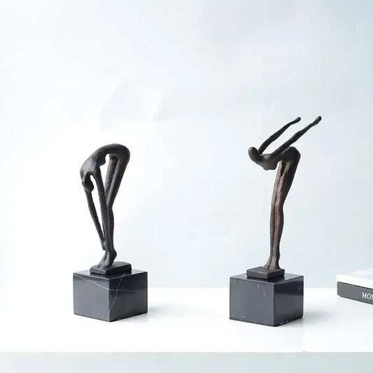 Two abstract bronze diving sportsman metal sculptures on black marble bases for living room decor