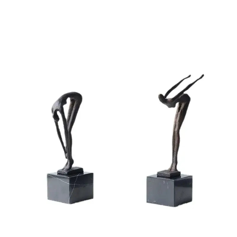 Two abstract bronze diving sportsman metal sculptures mounted on dark marble bases for living room decor