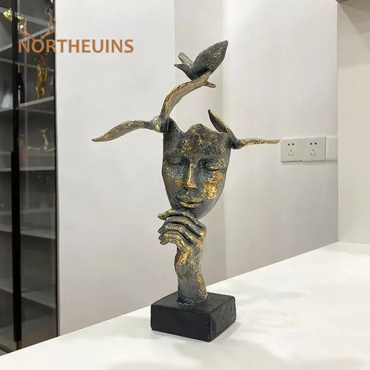 Bronze and gold toned abstract bird figurine statue with golden mask bird design on black base for office decor