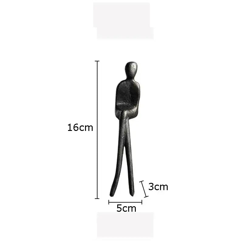 A sleek black metal sculpture set featuring a minimalist gold plated figure for decorbites living room decor