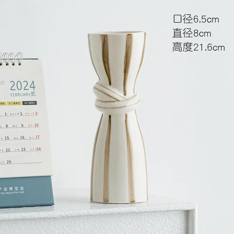 Cream-colored abstract ceramic hydroponic vase with gold vertical stripes and sculpted tied-waist double ear design