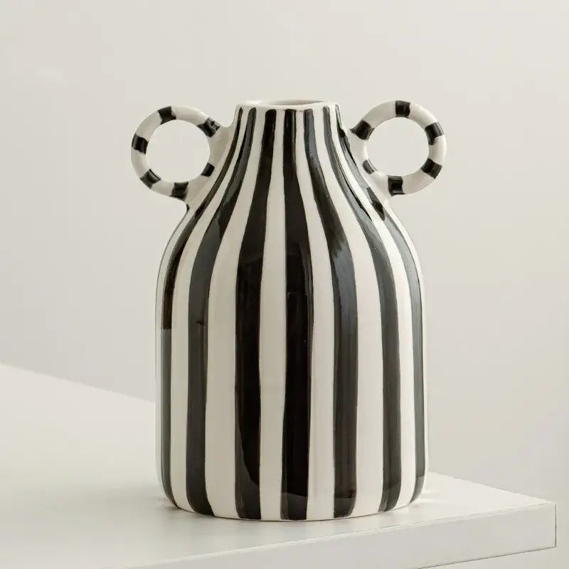 A sleek abstract ceramic hydroponic vase in black with bold vertical stripes and double ear handles