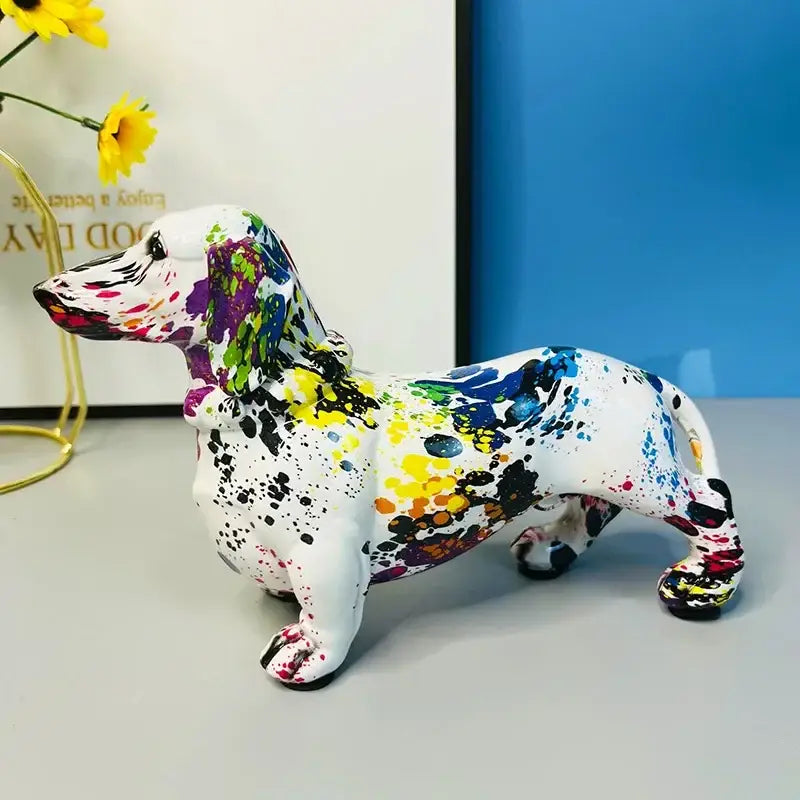A vibrant white ceramic colorful dachshund dog figurine with purple blue yellow black and pink paint splatters for living room decor