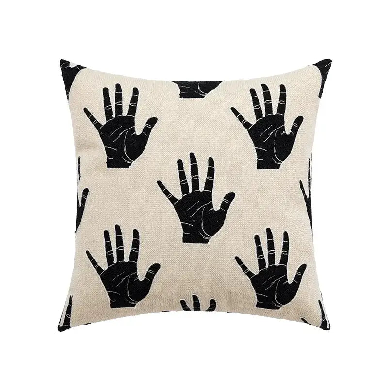 Beige abstract cream and black embroidered cotton cushion cover with repeating black hand print pattern for living room decorbites