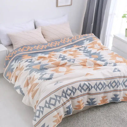 A cozy decorbites cotton nordic throw blanket in cream with blue and orange geometric tribal designs for bedroom decor
