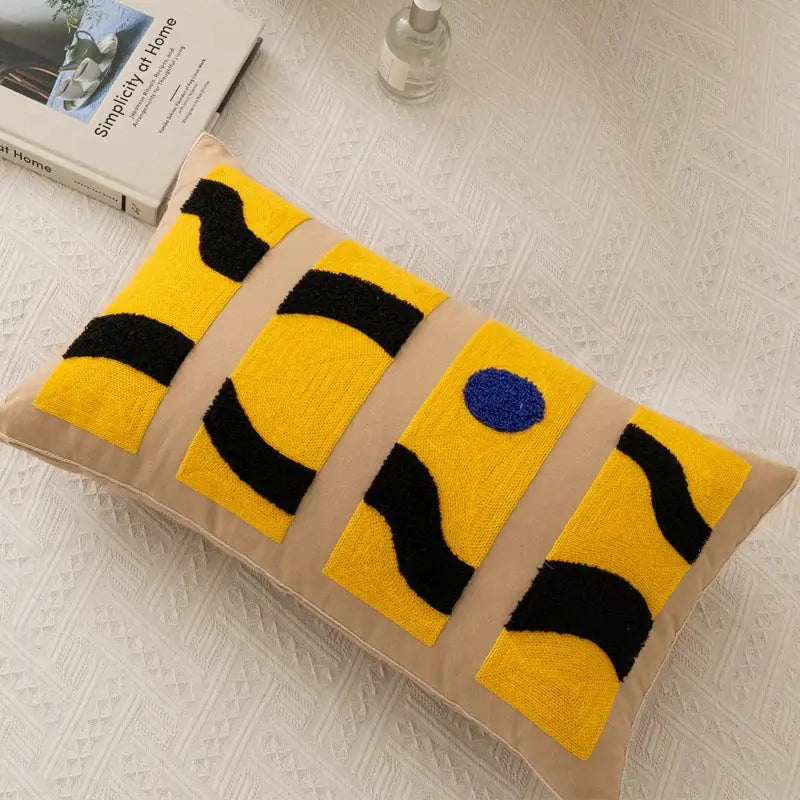Beige rectangular embroidery pillow cover with bold yellow black abstract pattern and blue circular detail for living room decor