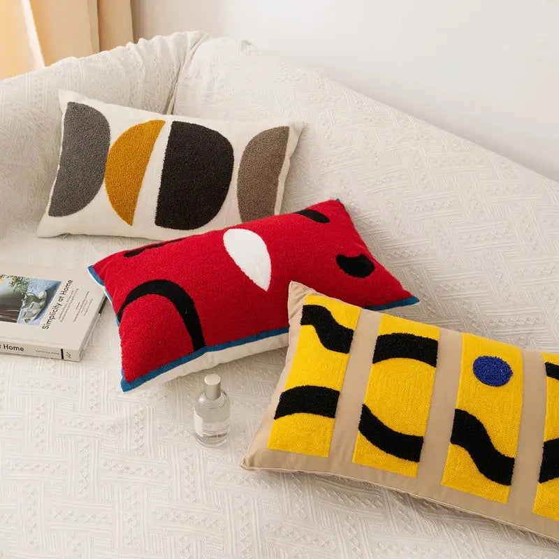 Three rectangular embroidery pillow covers with bold red yellow and black abstract pattern for living room decor
