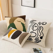 Three decorative throw pillows with embroidered abstract pattern pillow covers in earthy tones and black outlines for living room decor