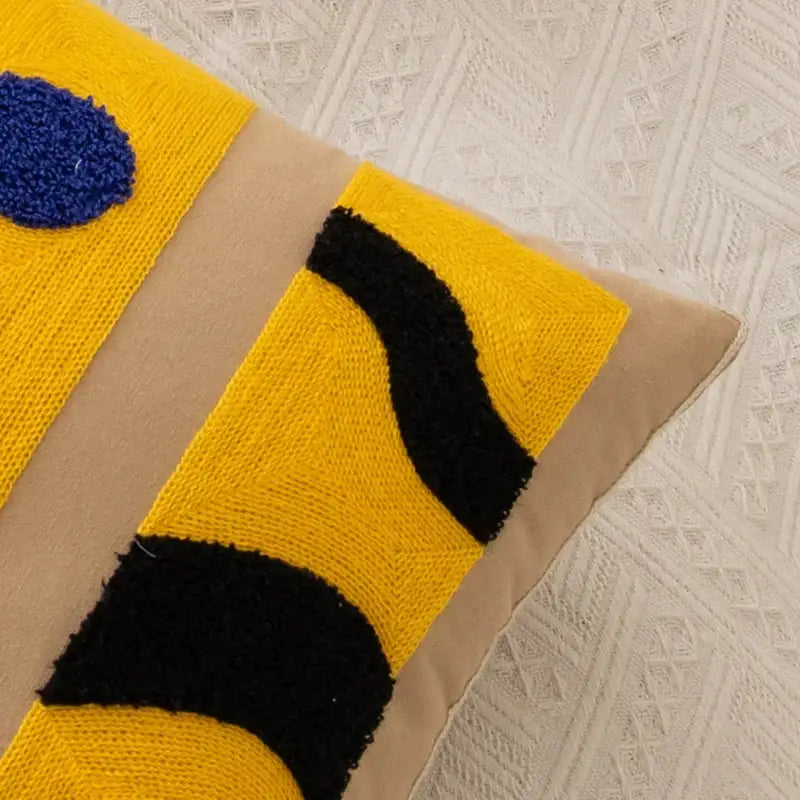 Abstract embroidery pillow cover with vibrant yellow black woven fabric and bold blue accent for living room decor