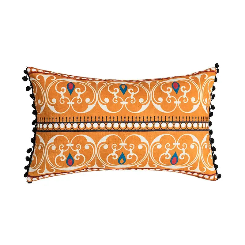 Orange and blue decorbites abstract geometric printed cushion cover with white ornate patterns and black pom-pom trim