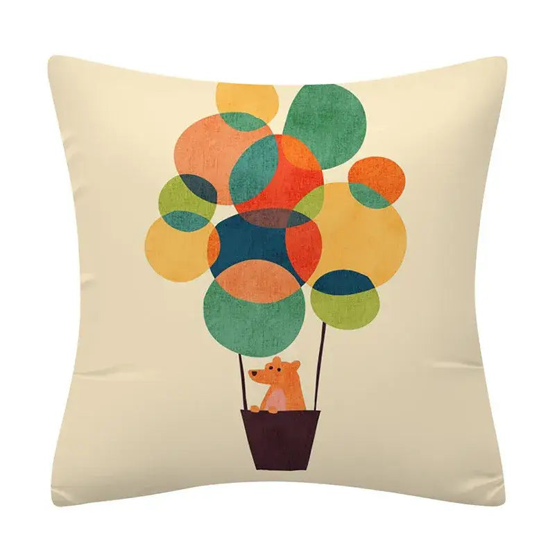 Cream-colored cushion cover with decorbites geometry pattern featuring an orange bear in a hot air balloon design