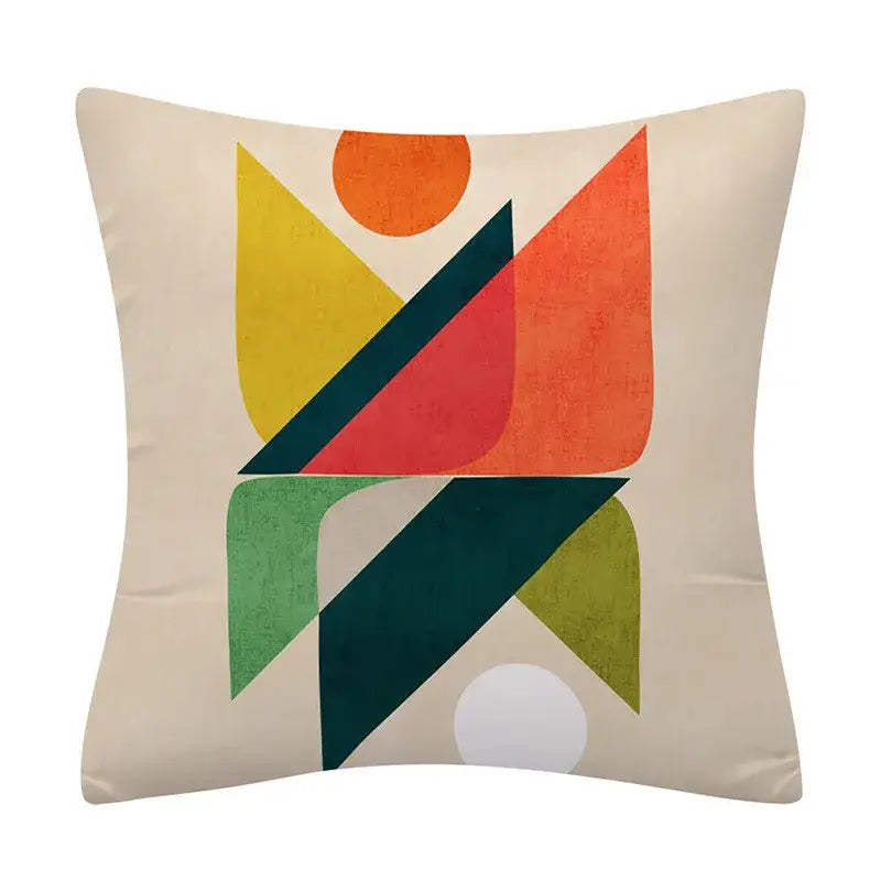Beige cushion cover with decorbites geometry pattern featuring bold yellow orange red green and teal shapes on textured background