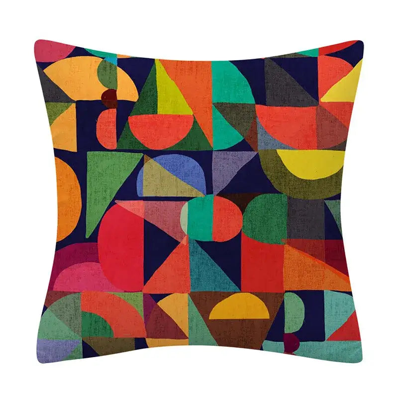 Vibrant geometry pattern cushion cover with bold reds oranges greens yellows and blues on dark navy background for decorbites