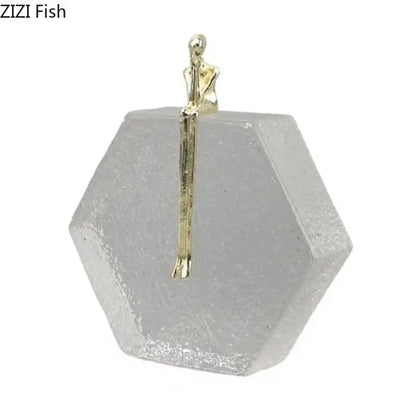 A delicate gold-toned abstract figures desk sculpture on a hexagonal decorbites crystal base for living room decor