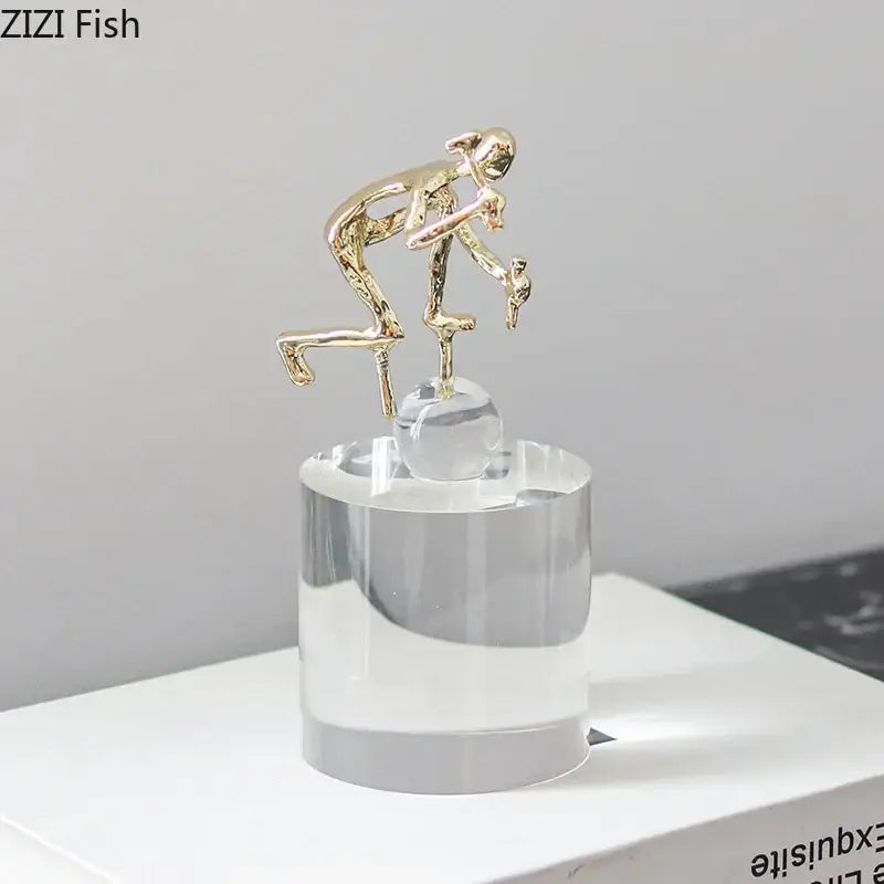 Gold-colored abstract figures desk decor featuring intertwined design on clear acrylic base by decorbites crystal sculpture