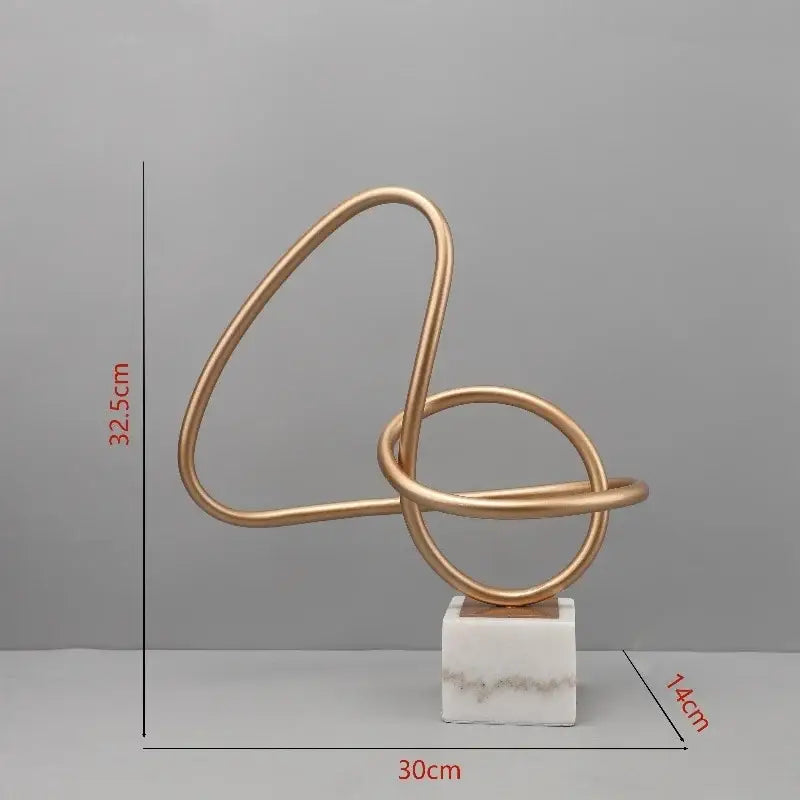 Gold-toned decorbites gold line geometric metal sculpture with intertwined loops on white marble base for living room decor