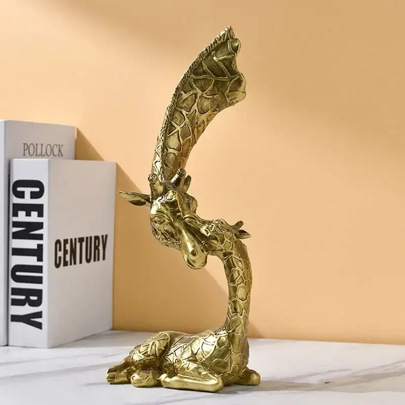 Golden abstract resin giraffe figurine with intricate textured skin and reclining pose for living room decorbites decor