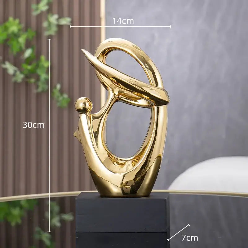 Golden geometric human decorative figurine with flowing polished metallic abstract sculpture for living room decorbites decor