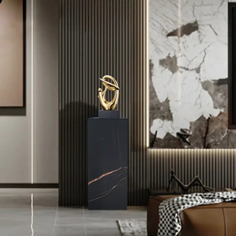Golden geometric human decorative figurine with flowing forms on black marble pedestal for living room decorbites decor
