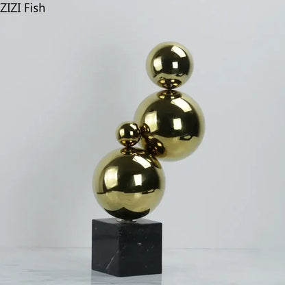 Abstract golden balls geometric metal sculpture with shiny gold metallic spheres stacked on black marble base for living room decor